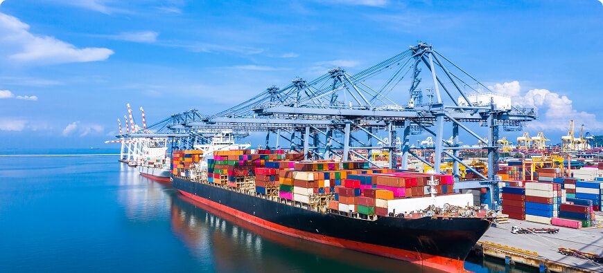 Container vessel berthed under gantry cranes at a container terminal