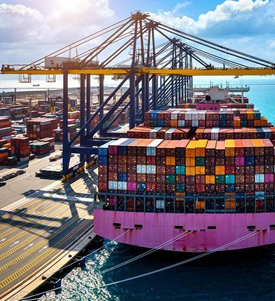 Container ship being loaded by gantry cranes at a port